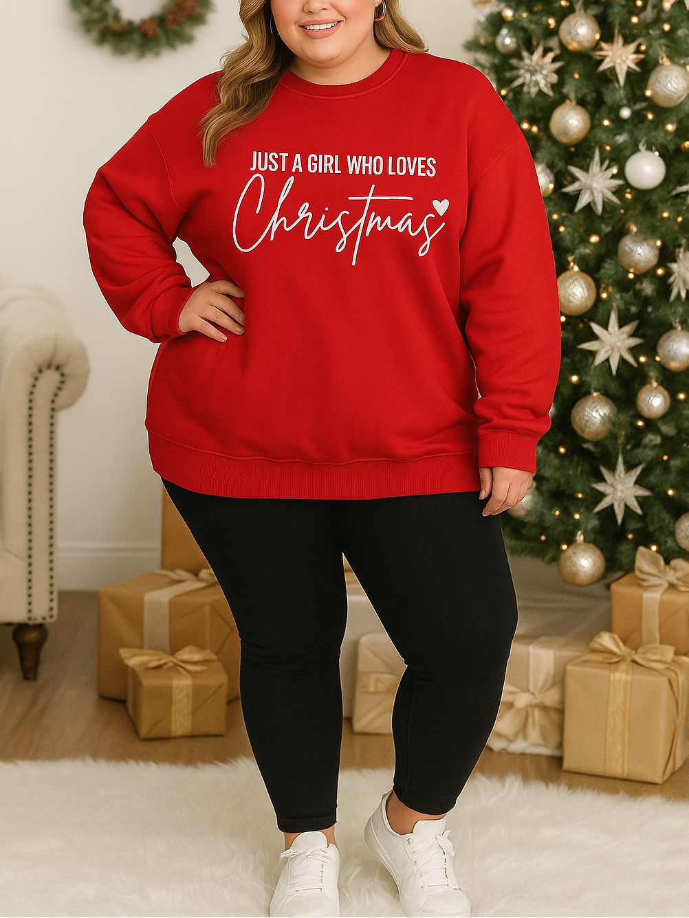 Woman wearing a red sweatshirt with Christmas-themed text in a festive living room.