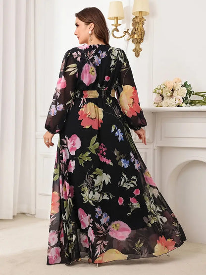 Woman wearing a black floral dress in an elegant room setting.