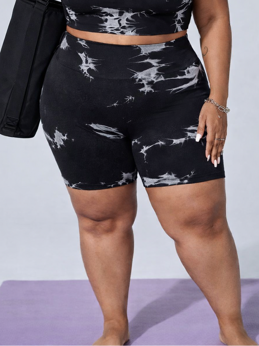 Person wearing a black and white patterned athletic outfit with a tote bag on a light gray background