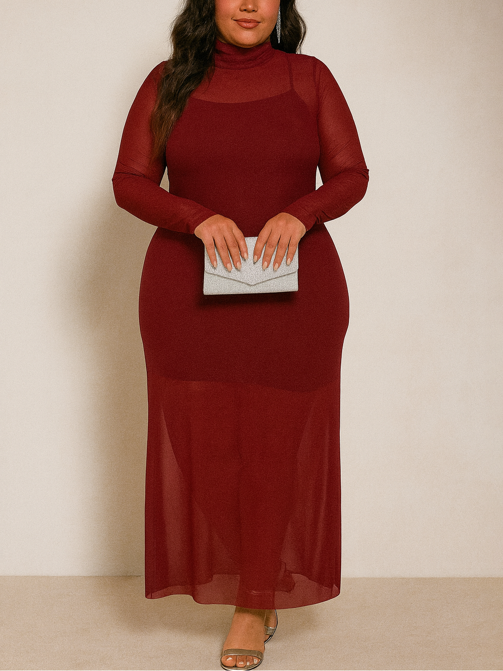 Woman wearing a burgundy dress holding a clutch against a plain background