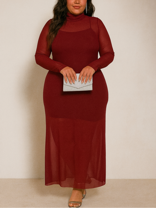 Woman wearing a burgundy dress holding a clutch against a plain background