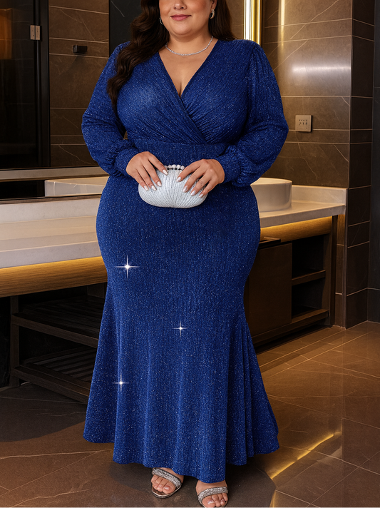 Woman in a blue dress holding a clutch in a bathroom setting