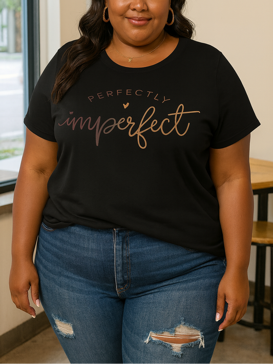 Woman wearing a black t-shirt with 'Perfectly Imperfect' text in a casual setting.