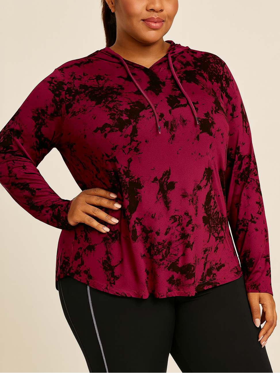 Woman wearing a maroon floral hoodie against a beige background