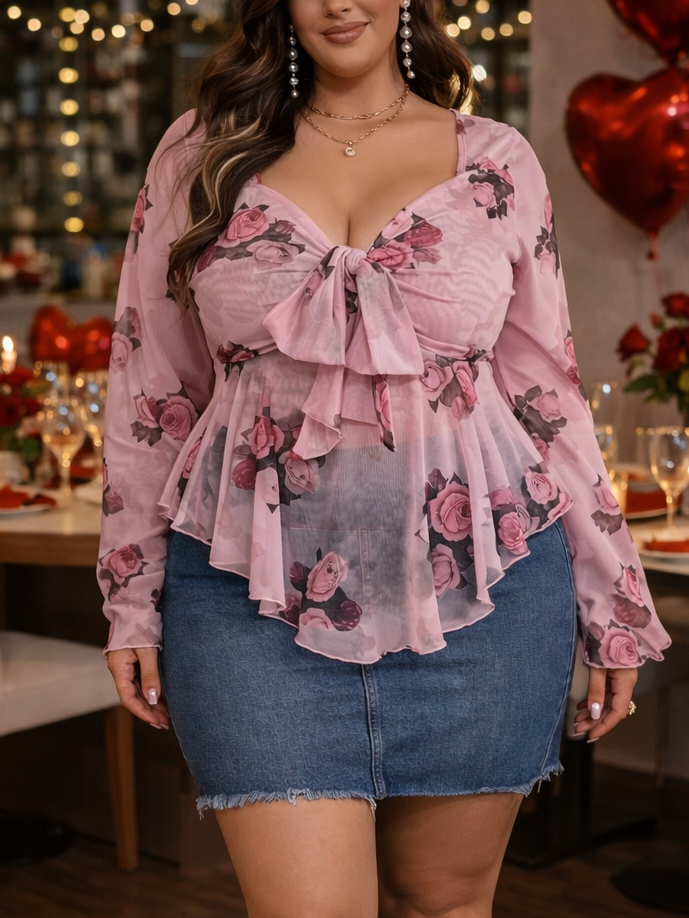 Woman in a floral blouse and denim skirt standing in a decorated room with heart balloons and candles.