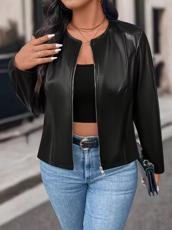 Person wearing a black leather jacket and blue jeans outdoors
