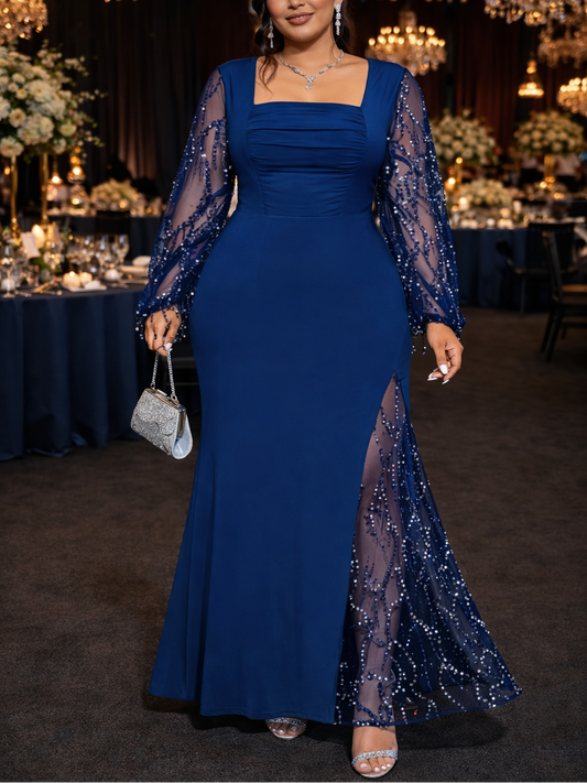 Woman in a blue evening gown with sheer sleeves at a formal event.