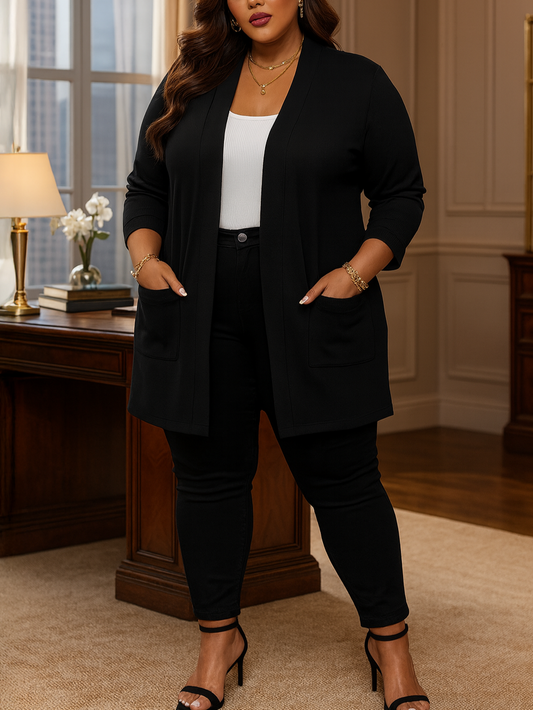 plus size Woman in a black outfit standing in an elegant room with wooden furniture and decor.