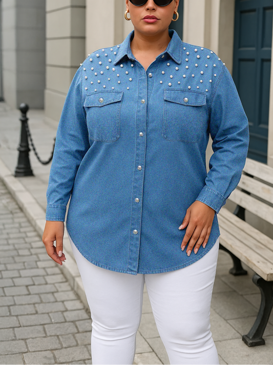 Woman wearing a blue studded shirt and white pants on a city street.