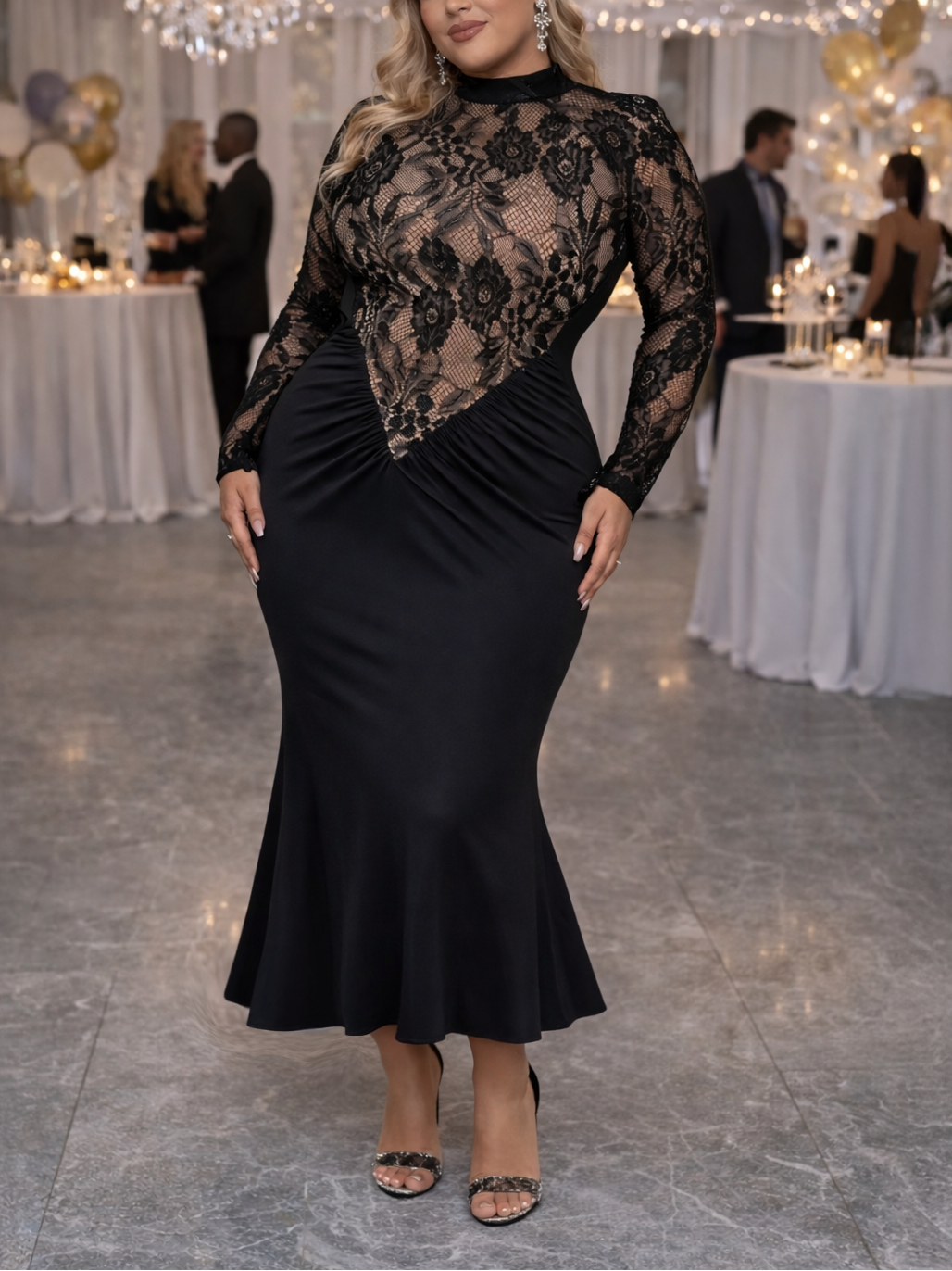 Woman in a black lace dress standing in a festive indoor setting with tables and decorations.
