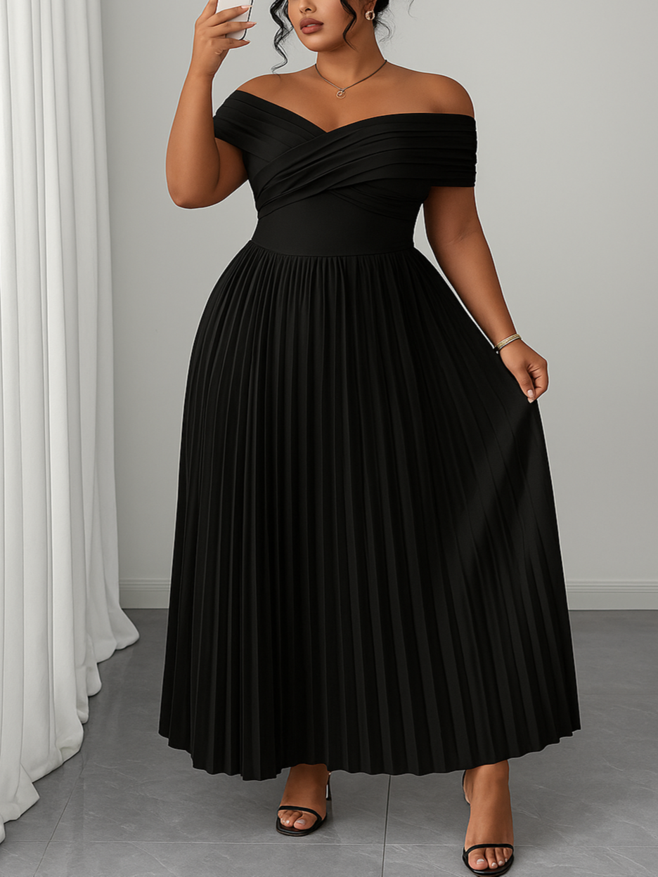 Woman wearing a black off-shoulder dress taking a mirror selfie.